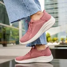 Foot wearing pink Skechers Slip-in shoe 
