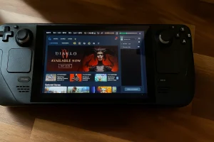 Steam Deck showing Diablo 4 game screen on wooden table with interface and controls clearly visible