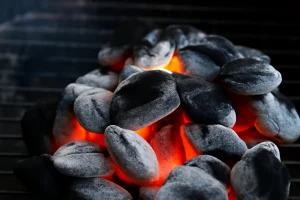 Best charcoal glowing briquettes emitting red-orange heat on a grill.
