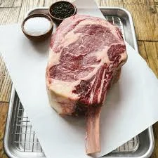 Best steak delivery featuring raw tomahawk ribeye with salt and pepper