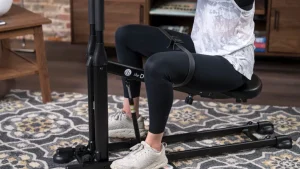 Fitness enthusiast using the db method machine for glute workout from the db method reviews