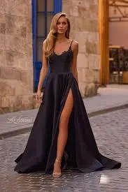 Woman in black dress with high slit.