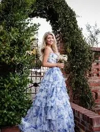 Woman in blue floral dress holding bouquet