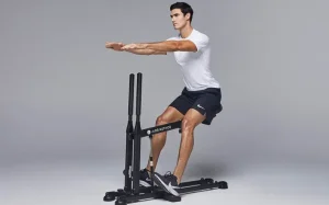 Fitness enthusiast using the db method machine for glute workout from the db method reviews