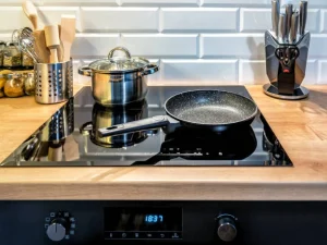 Induction cookware set neatly arranged in a modern kitchen