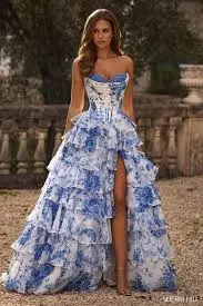 Elegant woman in blue floral gown outdoors