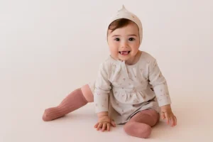 Cute baby in printed outfit and socks