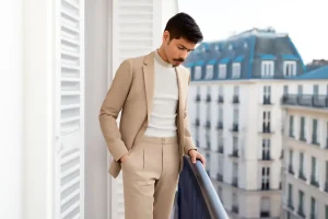 Man in beige suit on balcony